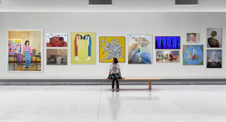 Web Banner - Young girl sat on bench admiring artwork 