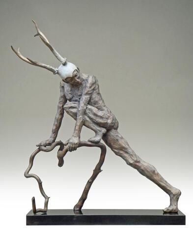 metal sculpture of a faun like figure
