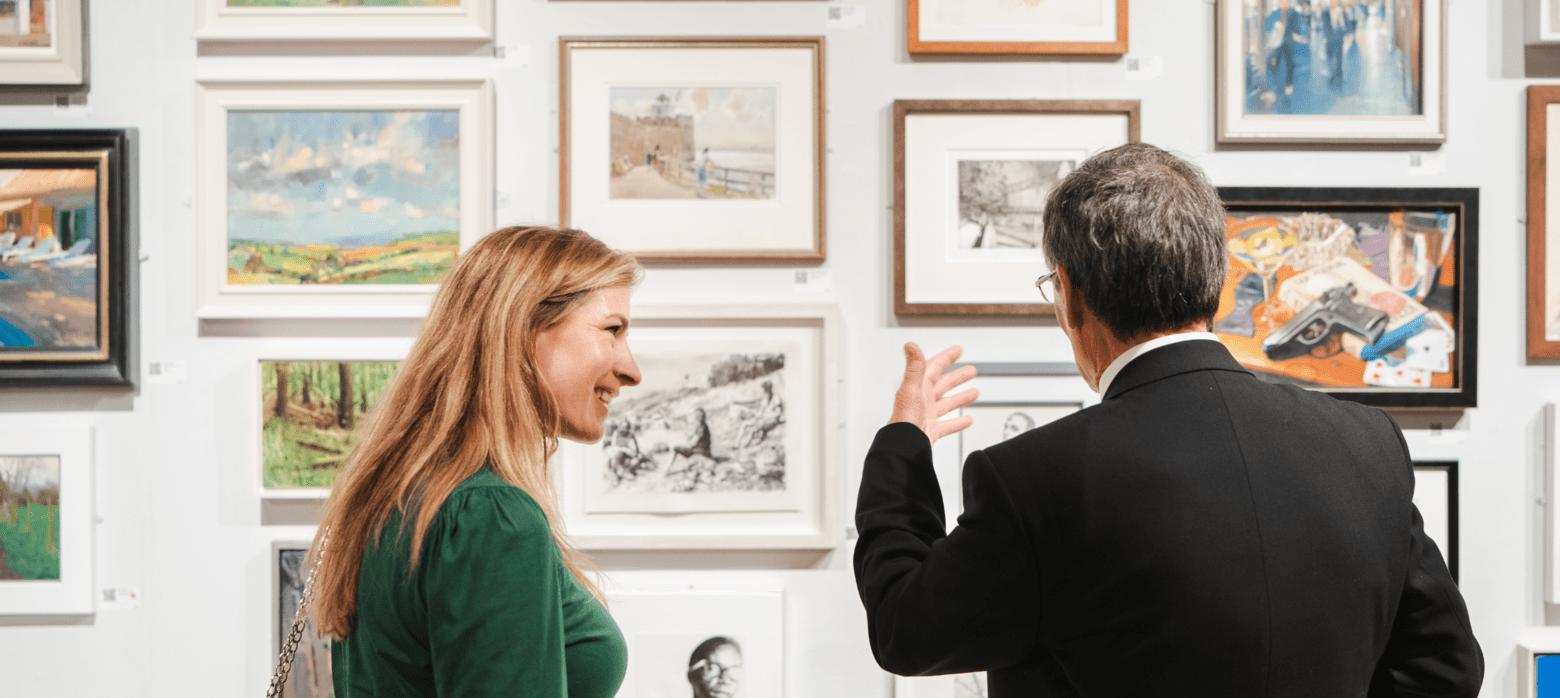 2 people looking at artwork