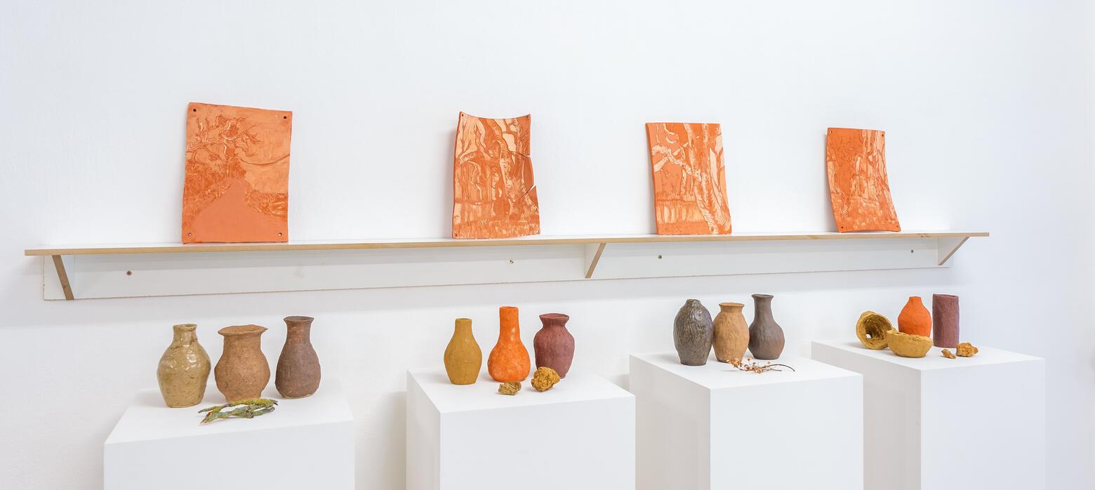 pots on plinths and pottery on shelf