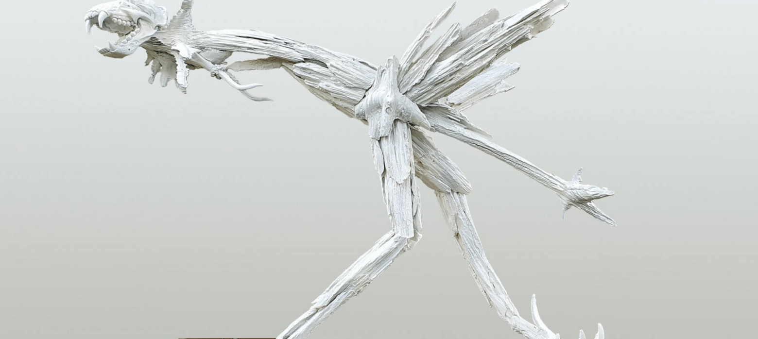 a white sculpture of a creature made of bones