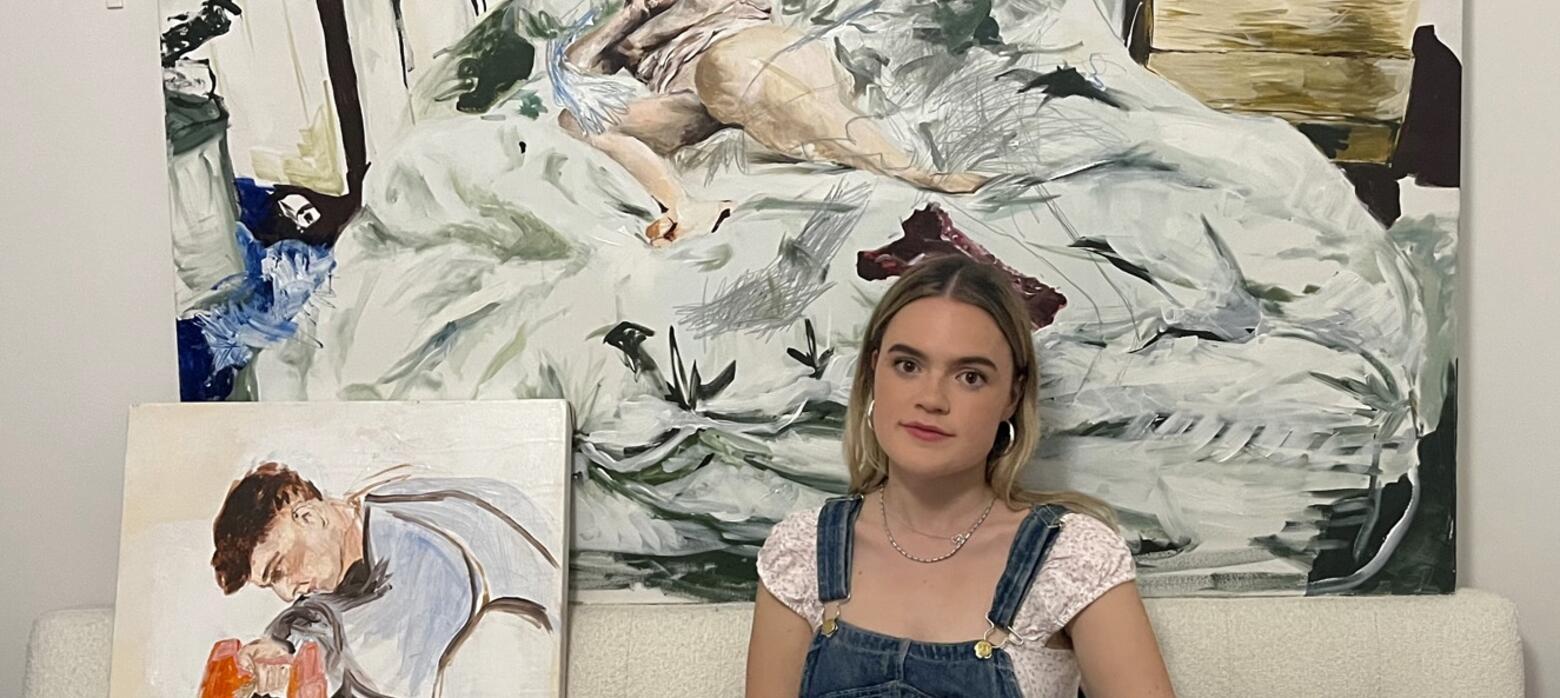 Eve McGuire in studio with painting behind her