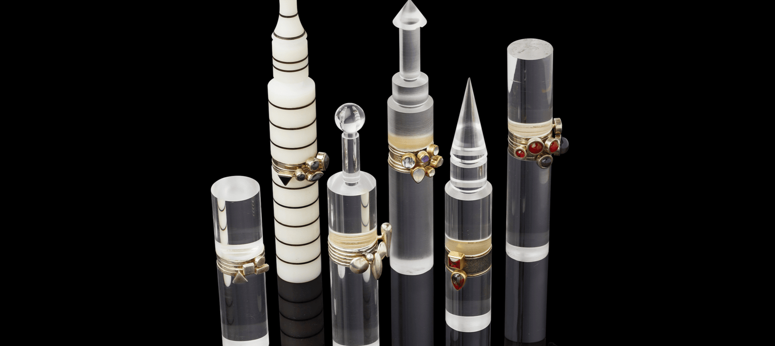 6 glass ring holders with rings presented on them