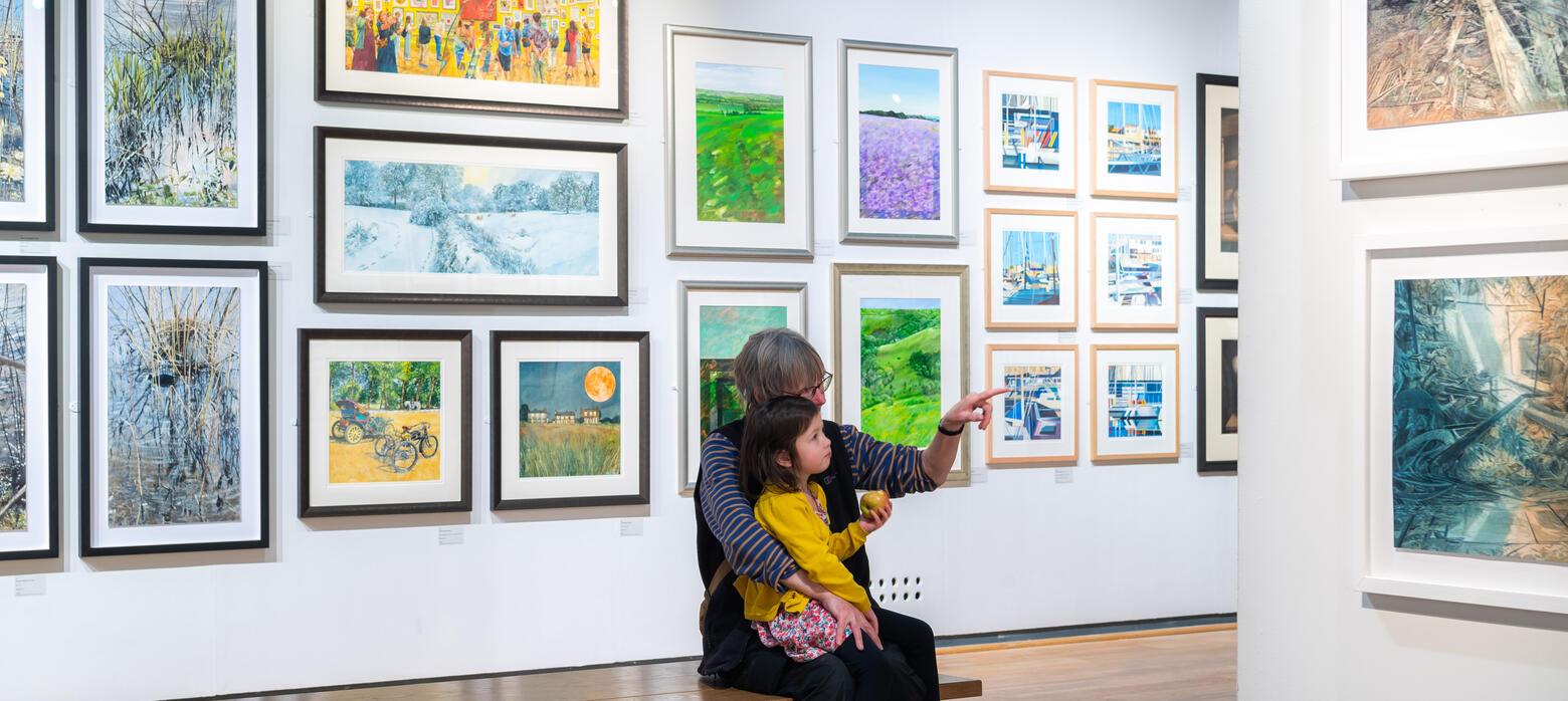 Family pointing at a watercolour painting