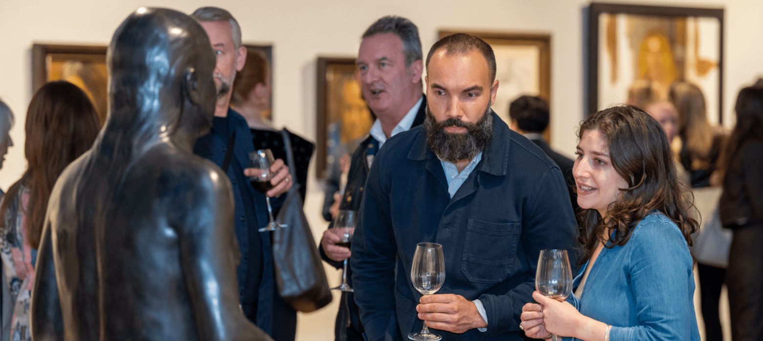 2 people looking at a sculpture in the west gallery