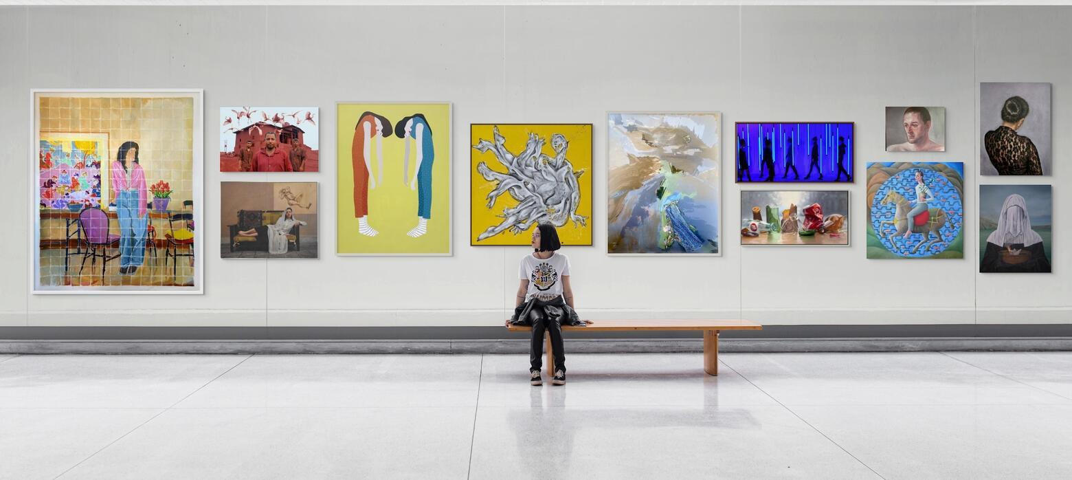 Web Banner - Young girl sat on bench admiring artwork 