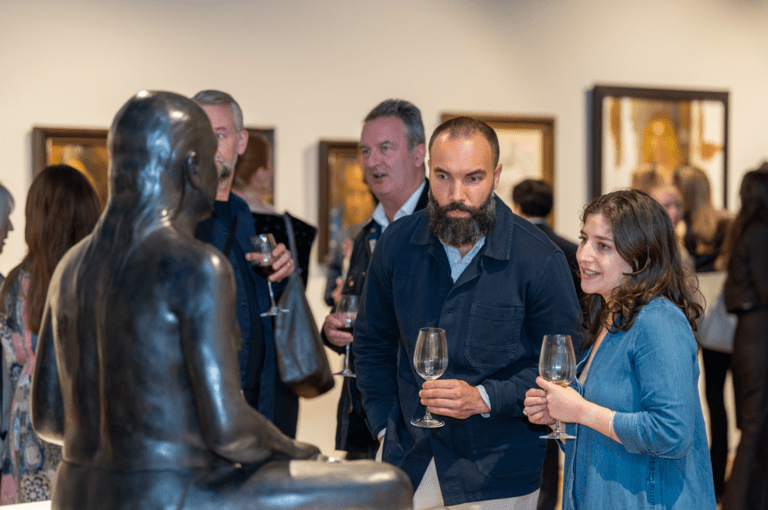 2 people looking at a sculpture in the west gallery