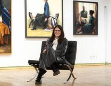 Photo of Martina sat on a chair during the RP Annual Exhibition