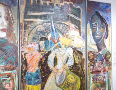 Sonia Lawson's large painting hung on the wall during the ROI exhibition at Mall Galleries. A young woman in an orange top is looking at the painting