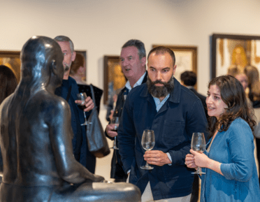 2 people looking at a sculpture in the west gallery