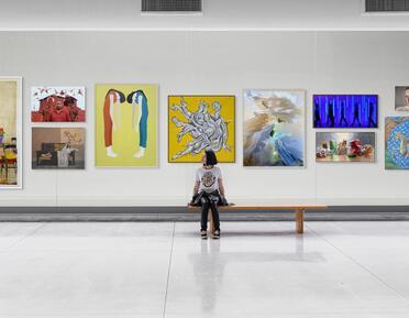 Web Banner - Young girl sat on bench admiring artwork 