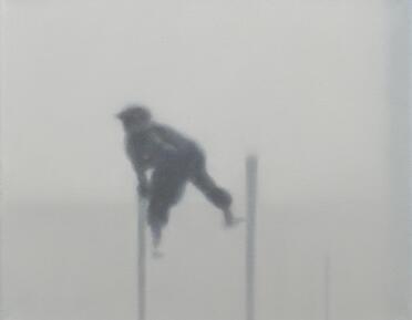 A figure moves through fog, or mist. 