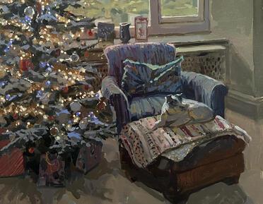 Dog on arm chair next to christmas tree